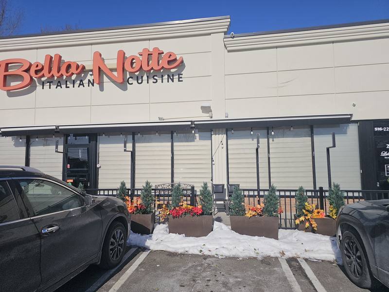 Restaurant storefront with shades fitted behind the full-height glazing
