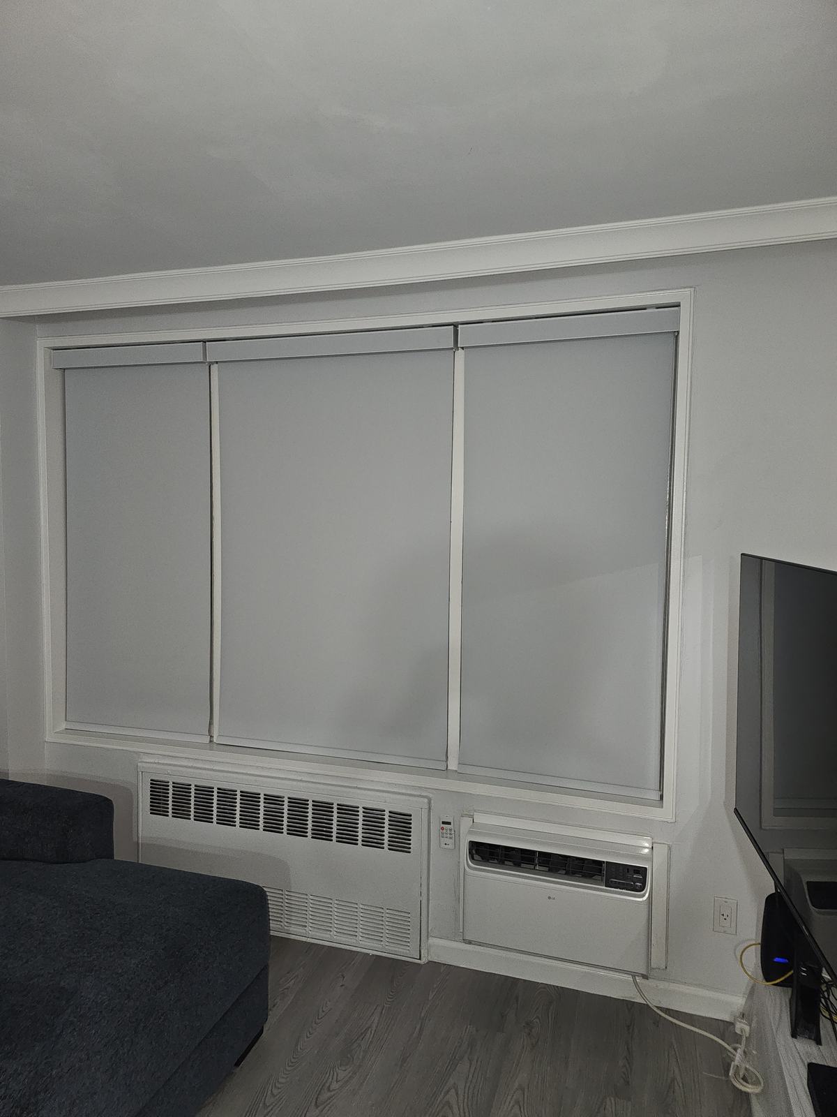 One wide roller shade covering a sliding glass door opening in a living space